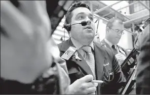  ?? AP/RICHARD DREW ?? Trader Joseph Lawler works Thursday on the floor of the New York Stock Exchange where the Standard & Poor’s 500 index and Dow Jones industrial average closed higher for the fifth straight day.