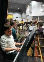  ?? BOB RAINES — DIGITAL FIRST MEDIA ?? Andrew Mikida, left, plays the piano as the North Penn Jazz Band prepares for their trip to New Orleans.