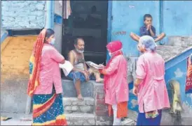  ??  ?? Asha workers speak to a resident during a door-to-door survey at JJ colony in Patparganj.
RAJ K RAJ/HT