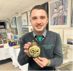  ??  ?? Japenese boy Auction assistant Ryan Nisbet with one of the jugs