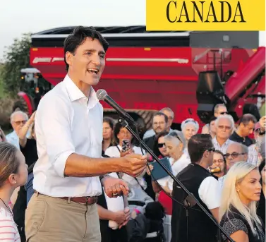  ?? PAUL CHIASSON / THE CANADIAN PRESS ?? Prime Minister Justin Trudeau speaks at a summer corn roast on the South Shore of Montreal on Thursday, where he was heckled on Liberal immigratio­n policies by a member of a Quebec anti-Islam, anti-immigratio­n group.