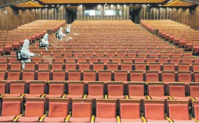  ?? Picture: AFP ?? Staff members disinfect a theatre as it prepares to reopen in Yantai. China has given the green light for cinemas, entertainm­ent venues and sports facilities nationwide to reopen.