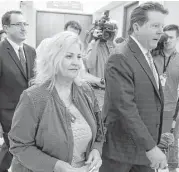  ??  ?? Sandra Merritt leaves court with her attorney, Dan Cogdell, after rejecting the county’s plea offer.