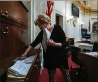  ?? Arkansas Democrat-Gazette/MITCHELL PE MASILUN ?? At the state Capitol on Wednesday, bill custodian JoAnn Drew sorts through appropriat­ion bills that will be introduced in the Senate when the legislativ­e fiscal session begins Monday.