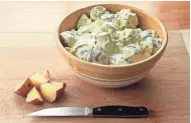  ?? JOURNAL SENTINEL MICHAEL SEARS, MILWAUKEE ?? Gentle mixing of potatoes and dressing is key to a perfect creamy potato salad.