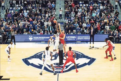  ?? Icon Sportswire / via Getty Images ?? UConn’s Josh Carlton (25) wins the jump ball over Arizona’s Chase Jeter at the start of a game in 2018 at the XL Center in Hartford.