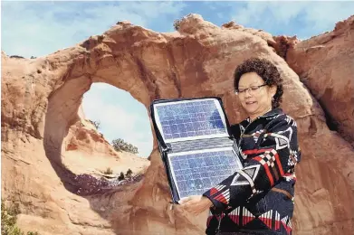  ?? RANDY MONTOYA/SANDIA NATIONAL LABORATORI­ES ?? Sandra Begay with a solar panel at Window Rock, Ariz.