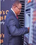  ?? ?? POSB chief executive officer Mr Garainashe Changunda transacts at one of the bank’s ATMs at Causeway Service Centre in Harare.