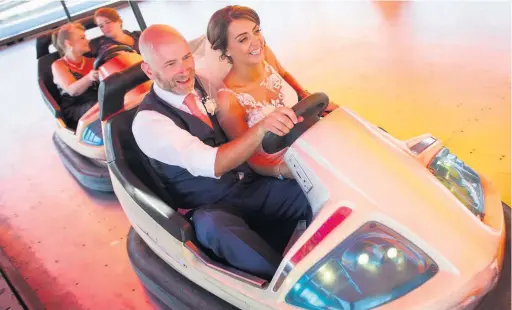  ?? MARK LEWIS ?? Russell and Tula Coxon having fun at the Coney Beach fairground after getting married in Porthcawl