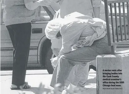  ?? RICH HEIN/SUN-TIMES FILE ?? A worker rests after bringing bodies into the Cook County medical examiner’s office during the 1995 Chicago heat wave.