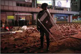  ?? VINCENT YU — THE ASSOCIATED PRESS ?? Police arrive on a street laid with bricks by protesters in Hong Kong on Wednesday.