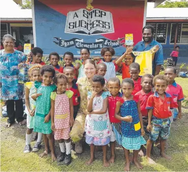  ?? DONATION: Lieutenant Jade Pregelj with students of Igam Elementary School in Lae. ??