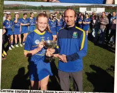  ??  ?? Carnew captain Alanna Dagge is presented with the Under-14 ‘B’ camogie cup by Wicklow Camogie chairman Serge Goetelen.