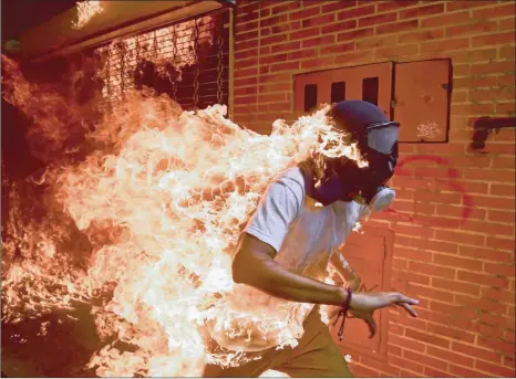  ?? PICTURE: RONALDO SCHEMIDT ?? José Víctor Salazar Balza, 28, catches fire amid violent clashes with riot police during a protest against President Nicolas Maduro, in Caracas, Venezuela.