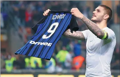  ?? ANTONIO CALANNI / AP ?? Inter's Mauro Icardi shows his jersey to fans as he celebrates netting the winner, which completed his hat-trick, in Sunday’s 3-2 Serie A derby victory over AC Milan on Sunday.