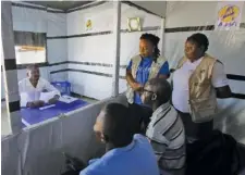  ?? AP PHOTO/AL-HADJI KUDRA MALIRO ?? Claude Mabowa Sasi, who lost his mother, a brother and a sister to Ebola, takes his college-entry exam in an isolation room Saturday at an Ebola treatment center in Beni, Congo.