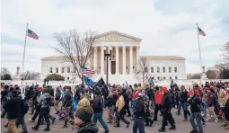  ?? JON CHERRY/GETTY ?? Pro-Trump backers march Jan. 6 in front of the Supreme Court. Many gathered in Washington to protest the ratificati­on of Joe Biden’s Electoral College victory.