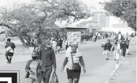  ??  ?? Scores of stranded commuters walk home as Zupco buses were grounded due to fuel shortages yesterday. — (Picture by Obey Sibanda)