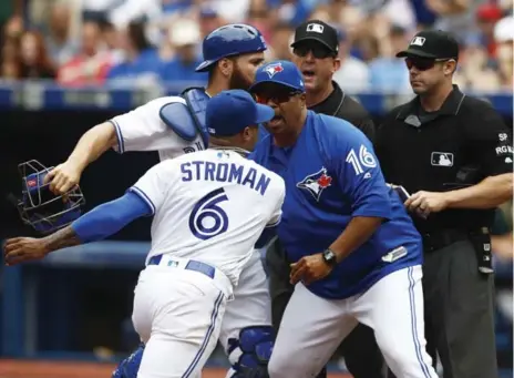  ?? MARK BLINCH/THE CANADIAN PRESS ?? Marcus Stroman has to be restrained by acting manager DeMarlo Hale after being ejected in the fifth inning by home-plate umpire Will Little, right.