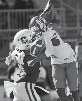  ?? STEPHEN DUNN/AP PHOTO ?? UConn defensive back Abiola Olaniyan (18) breaks up a pass intended for Houston wide receiver Marquez Stevenson (5) in the end zone during Saturday’s game in East Hartford. The Huskies lost 24-17.