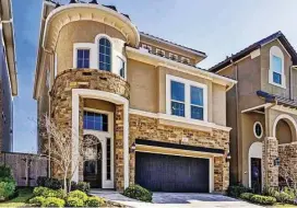  ?? Better Homes and Gardens Real Estate Gary Greene ?? This three-story, Mediterran­ean-style home is located in a gated waterfront community in Sugar Land.