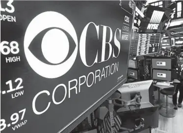  ?? RICHARD DREW/AP ?? The logo for the CBS Corporatio­n appears above a trading post Tuesday on the floor of the New York Stock Exchange.