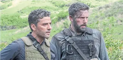  ?? MELINDA SUE GORDON TRIBUNE NEWS SERVICE ?? Oscar Isaac, left, and Ben Affleck in Triple Frontier, a weird movie with moments of machoness, humourless intensity and action.