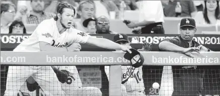  ?? Wally Skalij
Los Angeles Times ?? CLAYTON KERSHAW, ready to extend a hand (and cap) even when he isn’t starting, tries to catch a foul ball in the second inning.