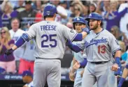  ?? Gene J. Puskar / Associated Press ?? David Freese is greeted by Dodgers teammates after hitting a first-inning grand slam in Pittsburgh.