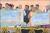  ?? HT ?? ▪ BJP president Amit Shah, flanked by railway minister Piyush Goyal and CM Yogi Adityanath and union minister of state for railways Manoj Sinha, displaying the prototype of train ticket mentioning Pandit Deen Dayal Upadhyaya station, in Mughalsara­i on...