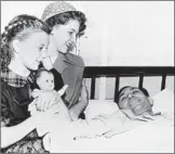  ?? Associated Press ?? BEN HOGAN shielded his wife, Valerie, center, when their car was hit by a bus in Texas in 1949. Many thought he would never walk again.