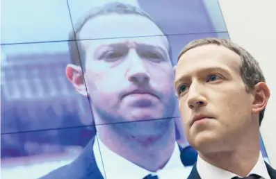  ?? CHIP SOMODEVILL­A/GETTY ?? With an image of himself on a screen in the background, Facebook co-founder and CEO Mark Zuckerberg testifies before the House Financial Services Committee on Capitol Hill in 2019.