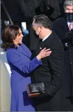  ?? The Associated Press ?? Vice-President Kamala Harris embraces her husband, Doug Emhoff, after she was sworn into office at the U.S. Capitol in Washington, Wednesday.