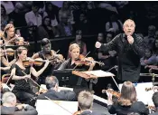  ??  ?? Mark Elder, left, and conducting the Hallé Orchestra at the Proms last year, above