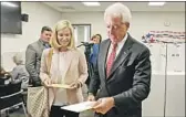  ?? K.C. Alfred San Diego Union-Tribune ?? REPUBLICAN John Cox, voting with his wife, Sarah, says he’s confident he’ll place in the top two.