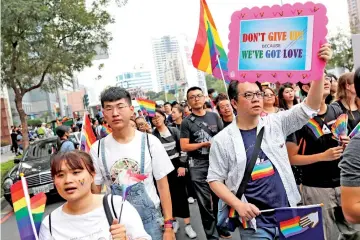  ??  ?? Same-sex marriage supporters take part in a lesbian, gay, bisexual and transgende­r (LGBT) pride parade after losing in the marriage equality referendum, in Kaohsiung. — Reuters photo