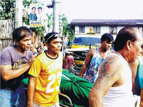  ?? SUNSTAR FOTO / ALEX BADAYOS ?? A LOSS. Neighbors of Duljo Fatima barangay-elect Ricardo Joel Ycong carry his lifeless body outside of his house so it will be brought to a funeral parlor.