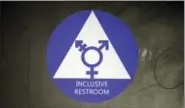  ?? ELAINE THOMPSON — THE ASSOCIATED PRESS FILE ?? A new sticker designates a gender neutral bathroom at Nathan Hale high school in Seattle.