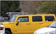  ??  ?? A man in a yellow hummer holds his communion bread out the sunroof to be blessed during the Easter Sunday service in the parking lot at St. Mark’s Lutheran Church in Birdsboro.
