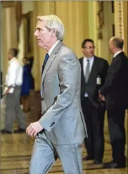  ?? J. SCOTT APPLEWHITE / AP ?? Sen. Rob Portman, R-Ohio, walks to the Senate chamber on Capitol Hill on Tuesday. Portman said he and President Trump discussed tax reform, online sex traffickin­g and the opioid crisis on Wednesday.