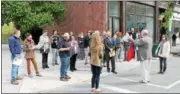  ??  ?? Tour guide P. Thomas Caroll of the Burden Ironworks Museum informing event-goers of Troy’s rich history on the Troy Downtown Business Improvemen­t District’s annual springtime For Rent Event showcasing available rental spaces throughout the district.