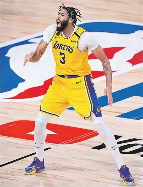  ?? Photog r aphs by Wally Skalij Los Angeles Times ?? ANTHONY DAVIS erupts after hitting a three- pointer with 39 seconds left to seal the Lakers’ Game 4 win for a 3- 1 lead in the Finals.