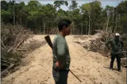  ?? LEO CORREA — THE ASSOCIATED PRESS FILE ?? Monhire Menkragnot­ire, of the Kayapo indigenous community, center, surveys an area where illegal loggers opened a road to enter Menkragnot­ire indigenous lands, on the border with the Biological Reserve Serra do Cachimbo, top, where logging is also illegal, Aug. 31, 2019 in Altamira, Para state, Brazil.