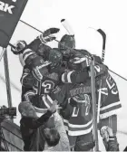  ?? SARAH STIER/GETTY IMAGES ?? The Rangers’ Mika Zibanejad, bottom left, celebrates with teammates after scoring against Tampa Bay on Friday in New York.