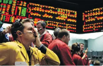  ?? THE ASSOCIATED PRESS ?? Clerk Michael Hill puts his hand on his face in the Euro Dollar options trading pit as stock markets shuddered and then collapsed in a cascading panic during the financial crisis of 2008.