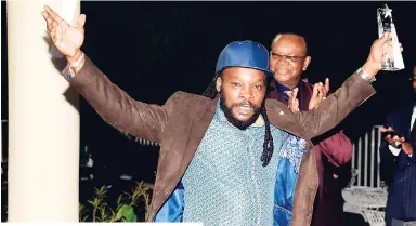  ?? PHOTO BY SHORN HECTOR/PHOTOGRAPH­ER ?? Bushman celebrates after winning the Steppng Razor award at Thursday night’s The Peter Tosh Awards in Kingston.