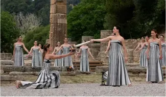  ?? ?? Actors light a torch at the o  cial   ame lighting for the Paris Olympics at the home of the ancient games in Greece.