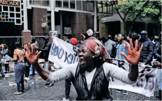  ?? HENK KRUGER African News Agency (ANA) ?? A WOMAN holds up her red-stained hands after police used inked water to try and remove protesting refugees from the offices of the UN High Commission­er for Refugees at the Waldorf Arcade in 2019. |