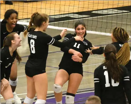  ?? MATTHEW MOWERY — MEDIANEWS GROUP ?? The Bloomfield Hills BlackHawks celebrate a point in their three-set, 25-15, 25-21, 25-20sweep of North Farmington in the Division 1 district opener on Monday.