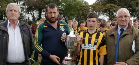  ??  ?? Derek Watchorn presenting the Wayne Watchorn Memorial Cup to Ryan Kielty in the presence of Des Croke (Coiste na nOg) and Brendan Furlong of People Newspapers (sponsors).